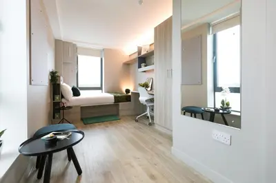 a living room with a table and a bedroom at For Students Aparto Caton Court Lancaster in Lancaster