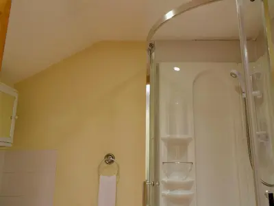 a bathroom with a shower with a glass door at West Boundary Farm Cottage 1 in Pilling