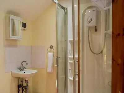 a bathroom with a shower and a sink at West Boundary Farm Cottage 1 in Pilling