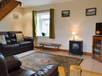 a living room with a couch and a fire place at West Boundary Farm Cottage 2 in Pilling