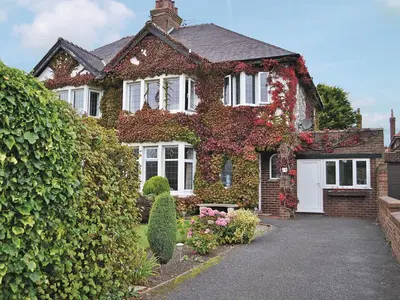 a house covered in ivy with a driveway at Ivy House in Saint Annes on the Sea