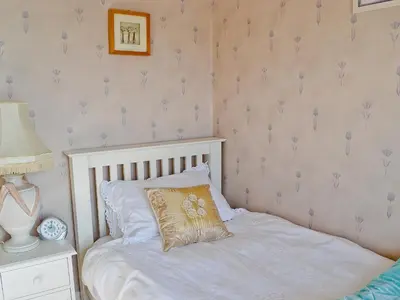 a bedroom with a bed with a pillow on it at Ivy House in Saint Annes on the Sea