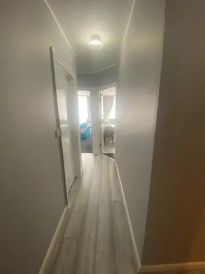 an empty hallway with a door and a room at Jackson Holiday Apartments in Blackpool