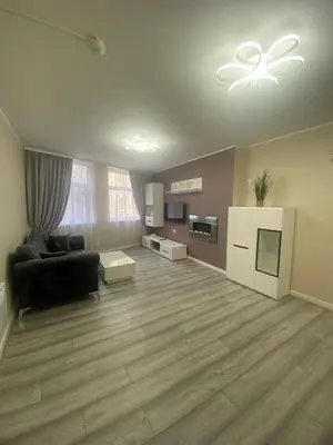 a large living room with a black couch and a table at Jackson Holiday Apartments in Blackpool