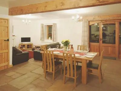 a dining room with a table and chairs at The Barn - 27977 in Whalley