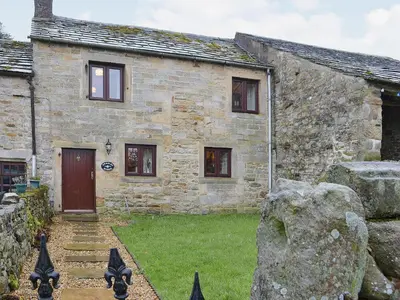 an old stone house with a yard in front of it at Bradley House in Harrop Fold
