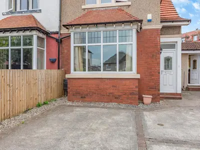 a brick house with a white door and windows at 15 Elms Road in Bare