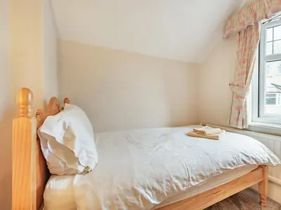 a small bedroom with a bed and a window at 15 Elms Road in Bare