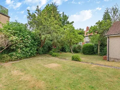 a yard with a tree and a house at 15 Elms Road in Bare