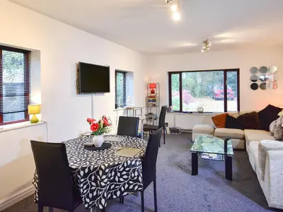 a living room with a table and a couch at South Lodge Cottage in Standish