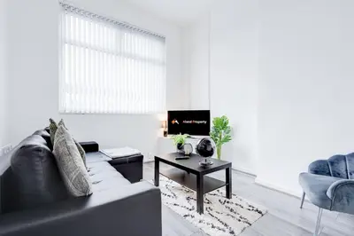 a living room with a couch and a table at Beautiful Apartment una - free public parking in Litherland