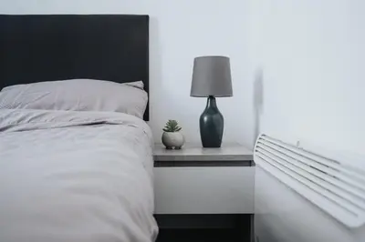 a bedroom with a bed and a lamp on a shelf at Beautiful Apartment una - free public parking in Litherland