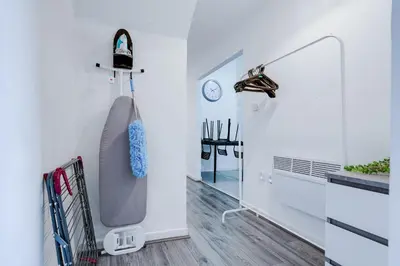 a bathtub in a white room with a mirror at Beautiful Apartment una - free public parking in Litherland