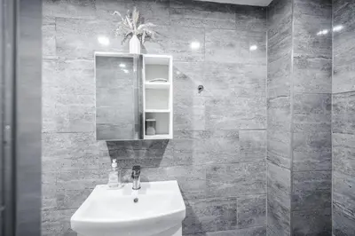 a bathroom with a sink and a mirror at Beautiful Apartment una - free public parking in Litherland