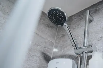 a shower head in a bathroom with a toilet at Beautiful Apartment una - free public parking in Litherland