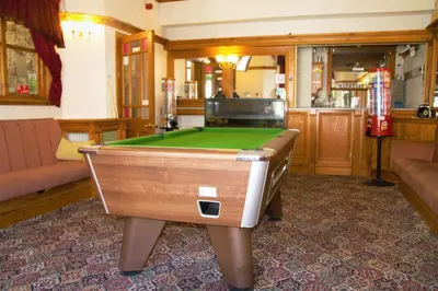 a room with a pool table in a bar at Pine Lodge Hotel in Blackpool