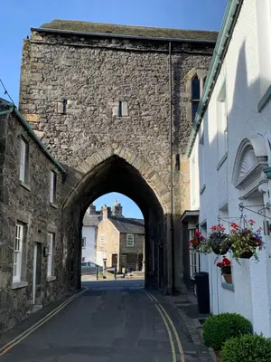 an archway in a stone wall in a street at Kents Bank Holiday - Pet Friendly with Bay Views in Grange Over Sands