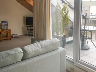 a living room with a couch in front of a window at Harbour Cottage in Millom