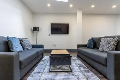 a living room with two couches and a tv at Temple Court by UStay Aparthotels in Liverpool