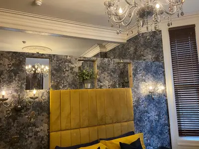 a living room with a couch and a chandelier at The New Talbot Hotel in Southport