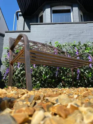 a wooden bench sitting on top of a pile of rocks at The New Talbot Hotel in Southport