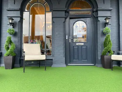 a front door of a store with a green floor at The New Talbot Hotel in Southport