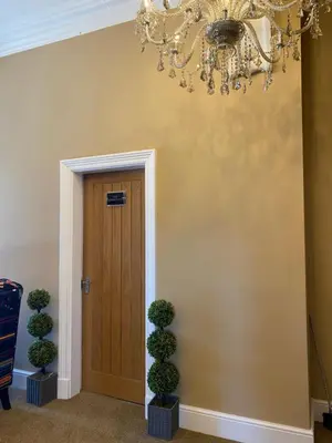a hallway with a chandelier and a door at The New Talbot Hotel in Southport
