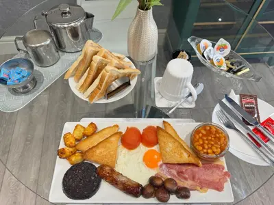 a plate of breakfast food on a glass table at B&B Runway Blackpool - Minutes From Winter Gardens - Dog Friendly - Exceptionally Quiet - Very Close H&A Social Club in Blackpool