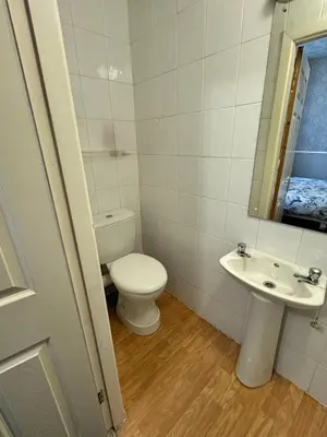 a white bathroom with a toilet and a sink at B&B Runway Blackpool - Minutes From Winter Gardens - Dog Friendly - Exceptionally Quiet - Very Close H&A Social Club in Blackpool