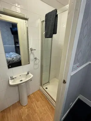 a bathroom with a sink and a shower at B&B Runway Blackpool - Minutes From Winter Gardens - Dog Friendly - Exceptionally Quiet - Very Close H&A Social Club in Blackpool