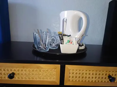 a black counter top with a tray of utensils at Harriette's Guest House in Blackpool