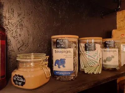 a shelf with three jars of honey and cheese at Harriette's Guest House in Blackpool