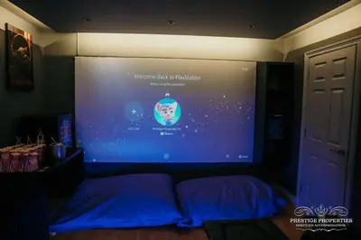 a large screen in a room with a bed at Princes st by Prestige Properties SA in Ulverston
