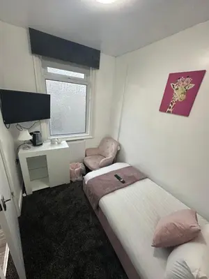 a small room with two beds and a television at Luxe Hotel Blackpool in Blackpool