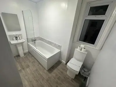 a white bathroom with a toilet and a sink at Luxe Hotel Blackpool in Blackpool