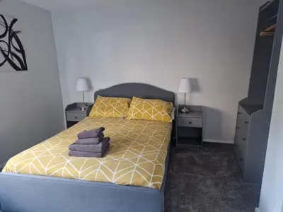 a bedroom with a bed with towels on it at Courtyard Cottage in Cartmel
