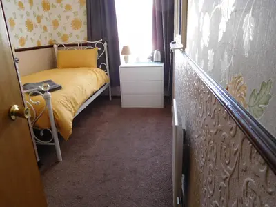 a small bedroom with a bed and a window at Bianca Guesthouse in Blackpool