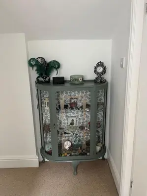 a green cabinet in a corner of a room at Cosy & Calm Escape by the Sea in Lytham St Annes