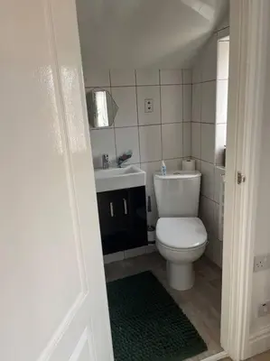 a bathroom with a white toilet and a sink at Cosy & Calm Escape by the Sea in Lytham St Annes