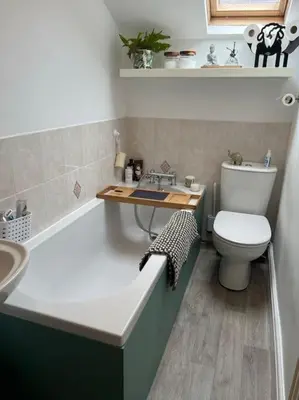a bathroom with a tub and a toilet and a sink at Cosy & Calm Escape by the Sea in Lytham St Annes