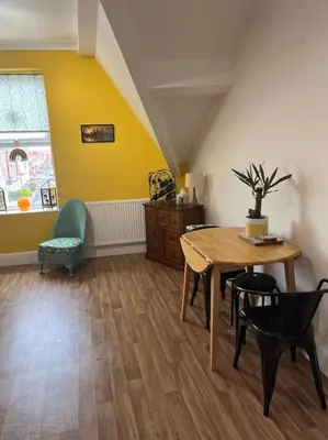 a dining room with a table and a chair at Cosy & Calm Escape by the Sea in Lytham St Annes