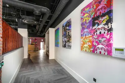a hallway with paintings on the walls of a building at Ropewalks Hotel in Liverpool