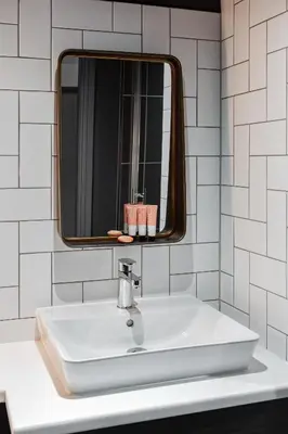 a white sink in a bathroom with a mirror at Ropewalks Hotel in Liverpool