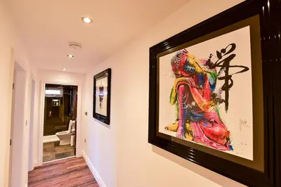 a painting hanging on a wall in a hallway at Wayside Lodge in Blackpool