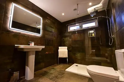 a bathroom with a sink and a toilet and a window at Wayside Lodge in Blackpool