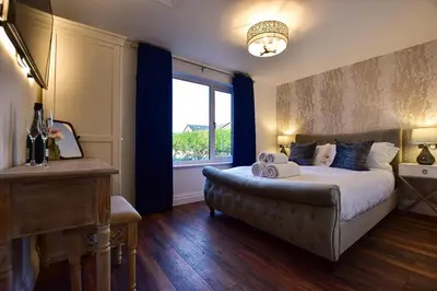 a bedroom with a large bed and a window at Wayside Lodge in Blackpool