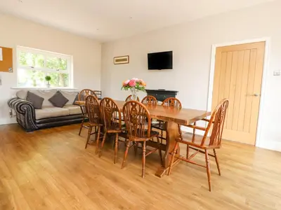 a dining room with a table and chairs and a couch at Homewood in Preston