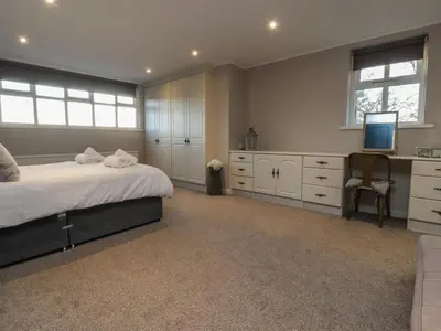 a bedroom with a bed and a television in it at Homewood in Preston