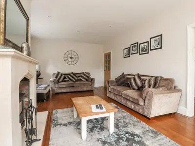 a living room with two couches and a fireplace at Homewood in Preston