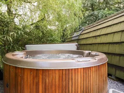 a hot tub sitting next to a fence at Homewood Pod in Preston